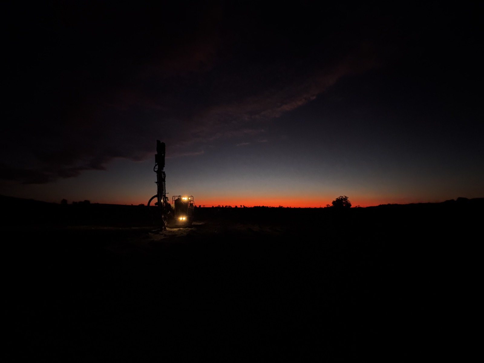 Two drill rigs working beside civil infrastructure