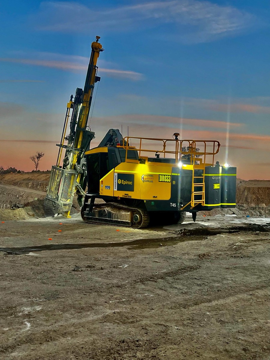 Drill rig silhouetted against a red sunset